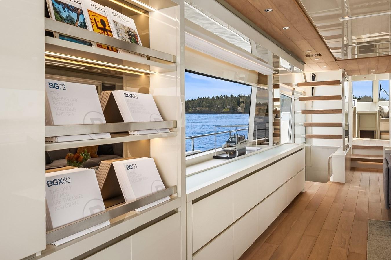 a room with a large window and a wood floor aboard SANLORENZO SX88/81 Yacht for Sale