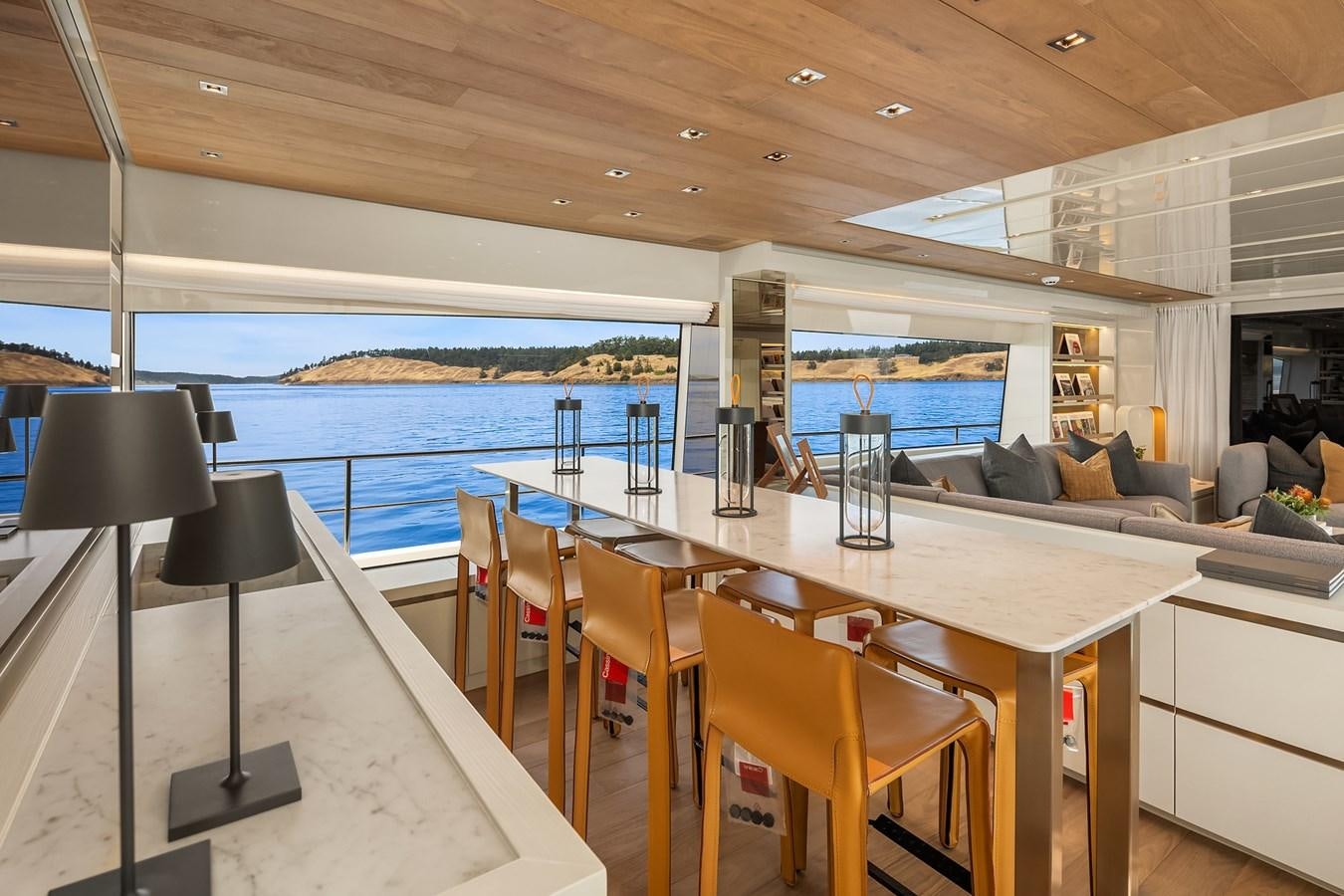a large table with chairs around it aboard SANLORENZO SX88/81 Yacht for Sale