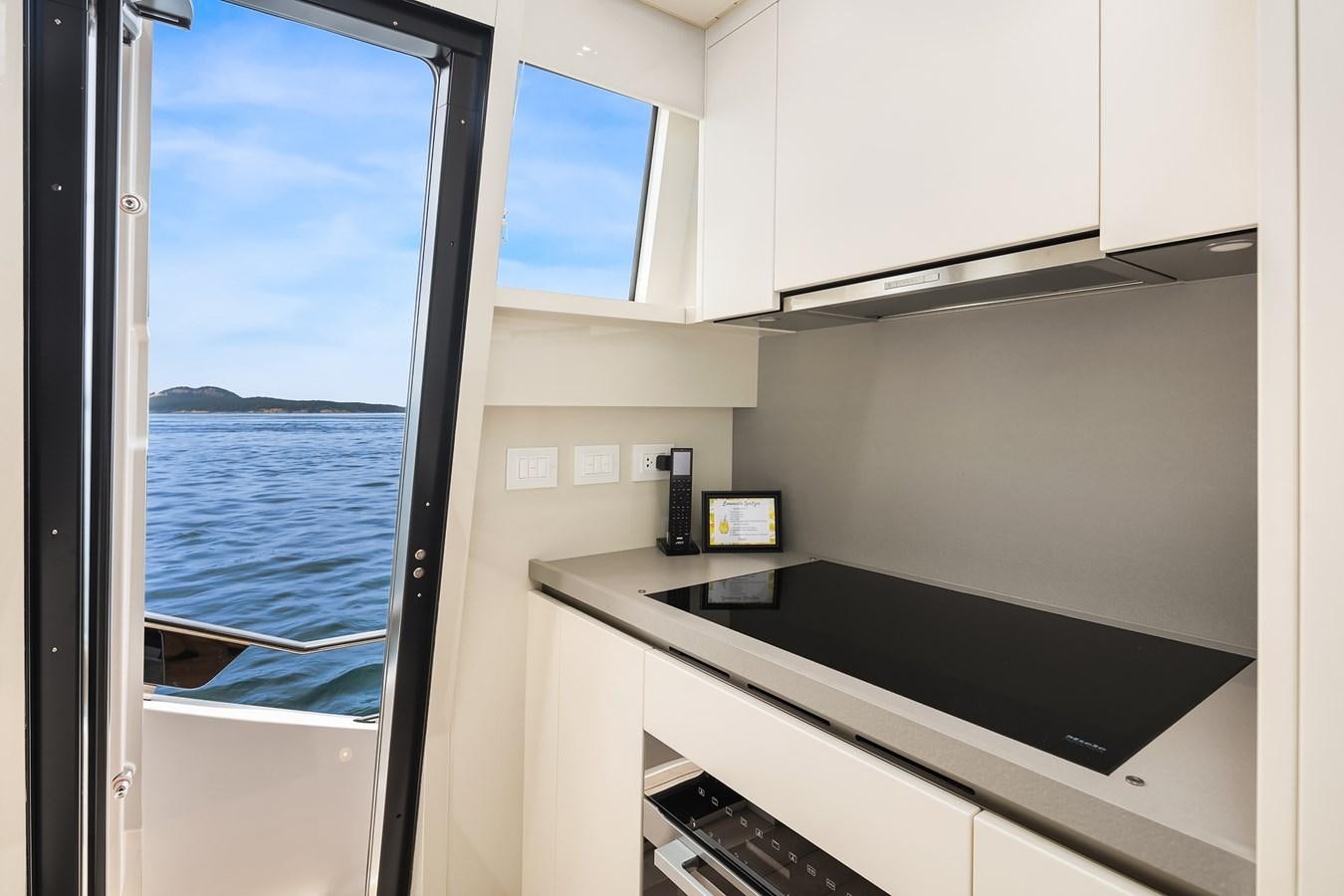 a kitchen with a sliding glass door aboard SANLORENZO SX88/81 Yacht for Sale