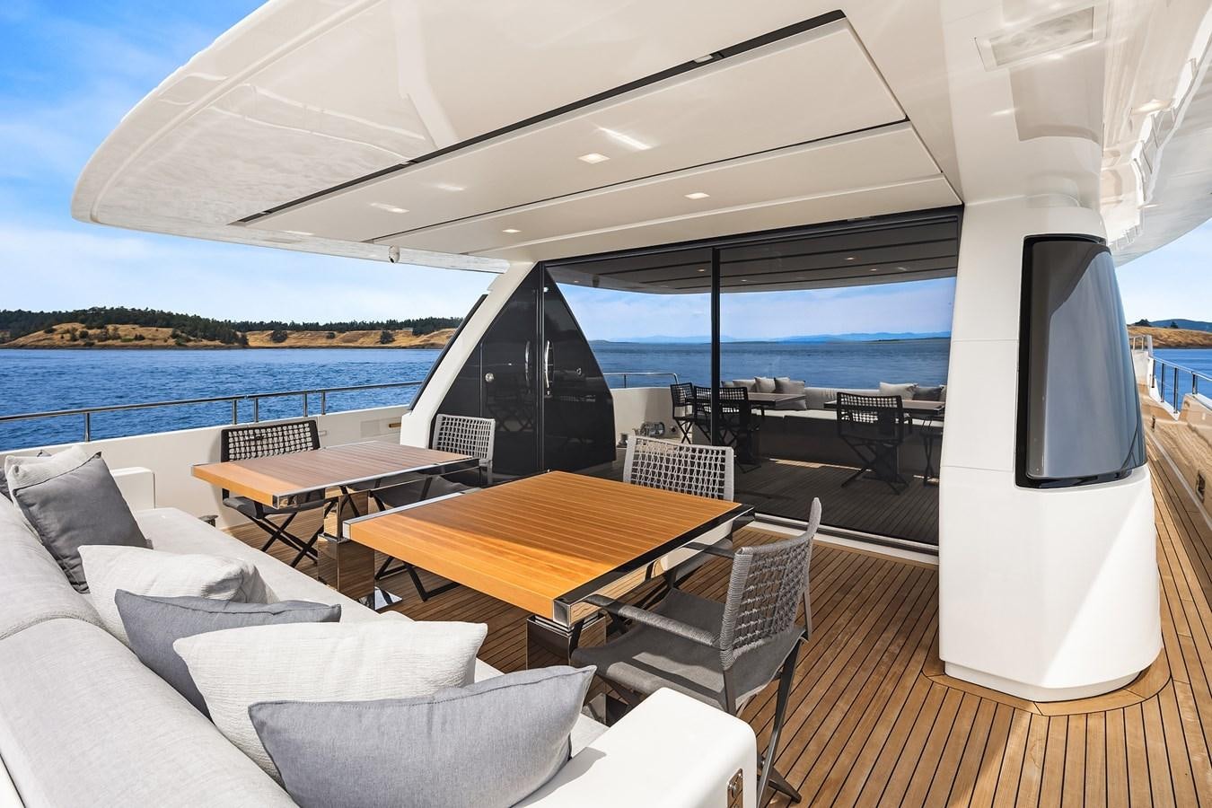 a room with a table and a tv on the wall aboard SANLORENZO SX88/81 Yacht for Sale