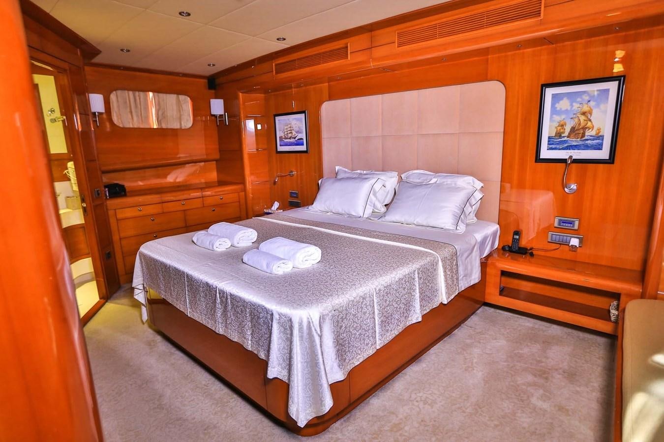 a bed with white sheets aboard GULMARIA Yacht for Sale