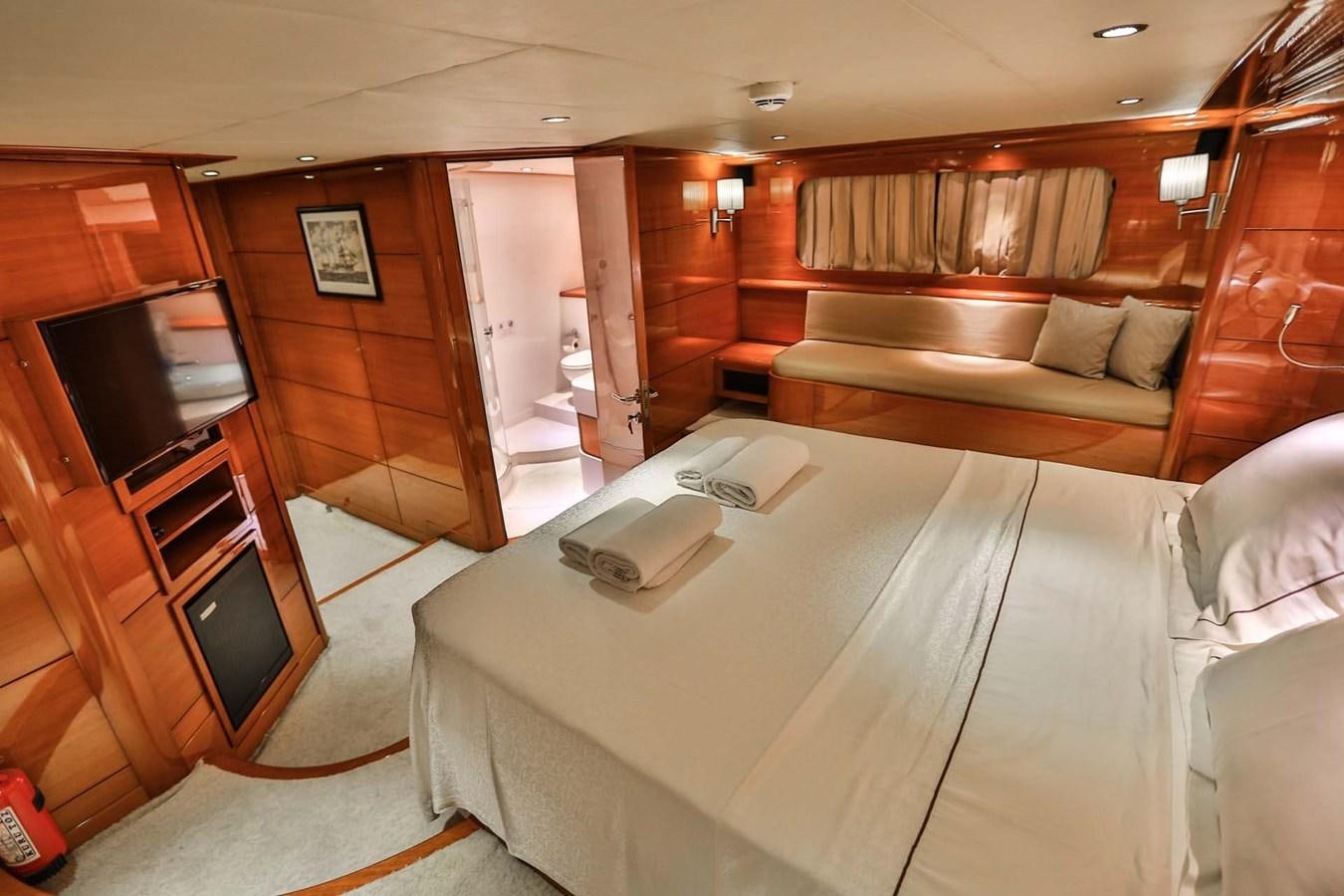 a room with a bed and a couch aboard GULMARIA Yacht for Sale