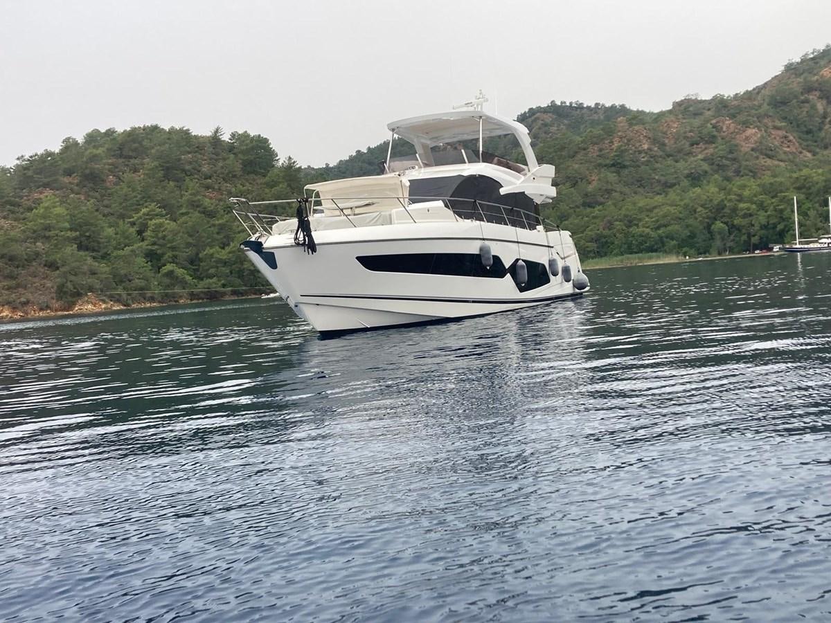 a white boat on water aboard CENGIZ Yacht for Sale