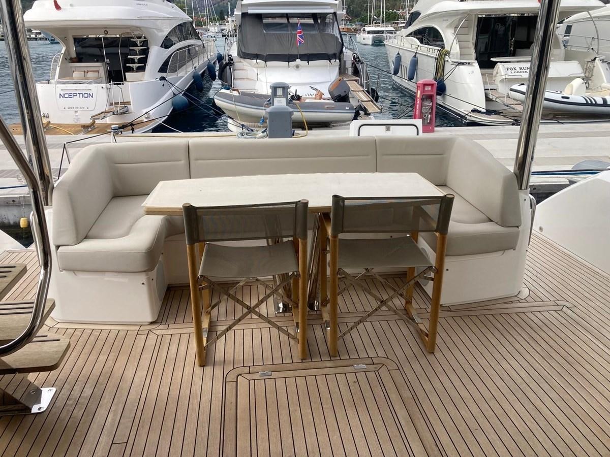 a table and chairs on a boat aboard CENGIZ Yacht for Sale