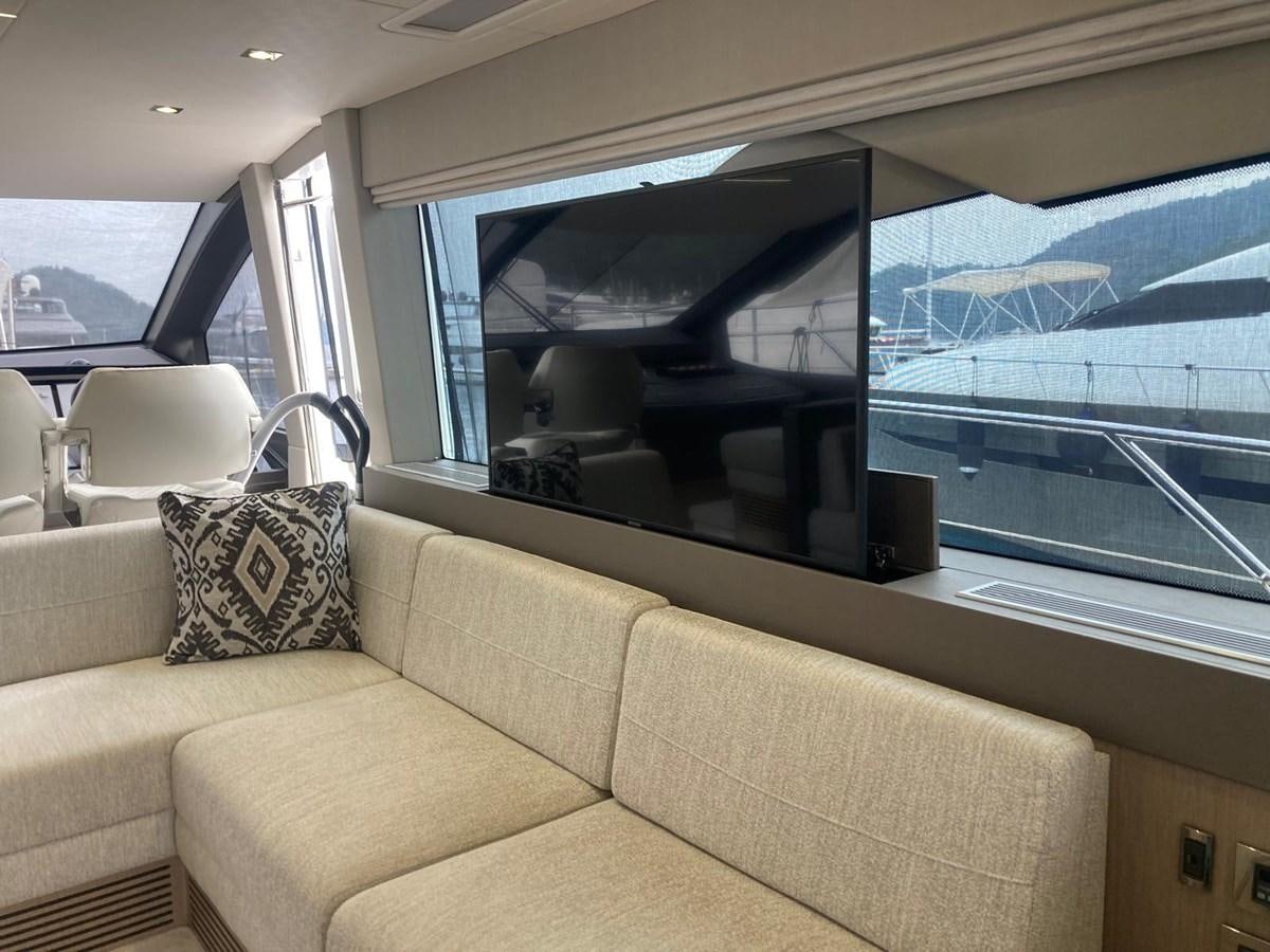 a beige couch in a car aboard CENGIZ Yacht for Sale