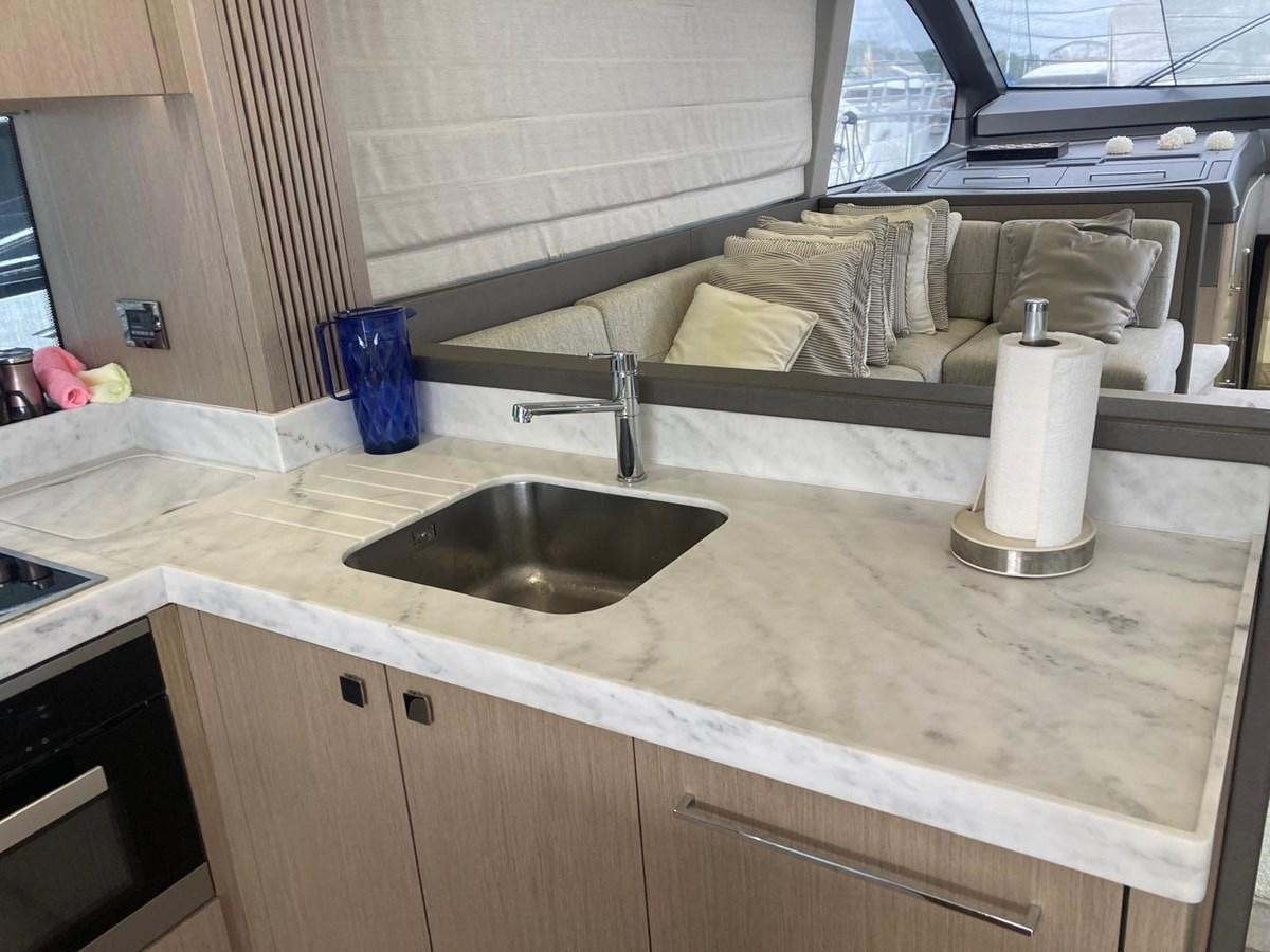 a kitchen with a sink and a bed aboard CENGIZ Yacht for Sale