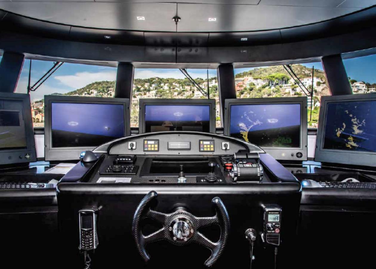 a group of computers on a table aboard ALI BABA Yacht for Sale