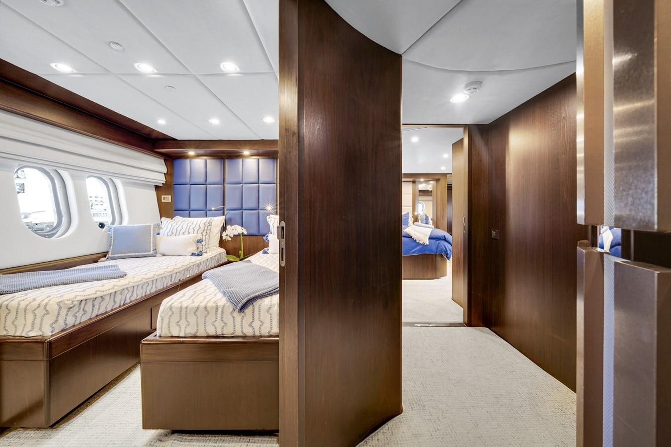 a room with a bed and a large window aboard MOONEN ROYAL DENSHIP 120 Yacht for Sale