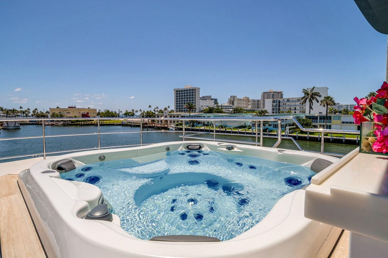a pool with a city in the background aboard MOONEN ROYAL DENSHIP 120 Yacht for Sale