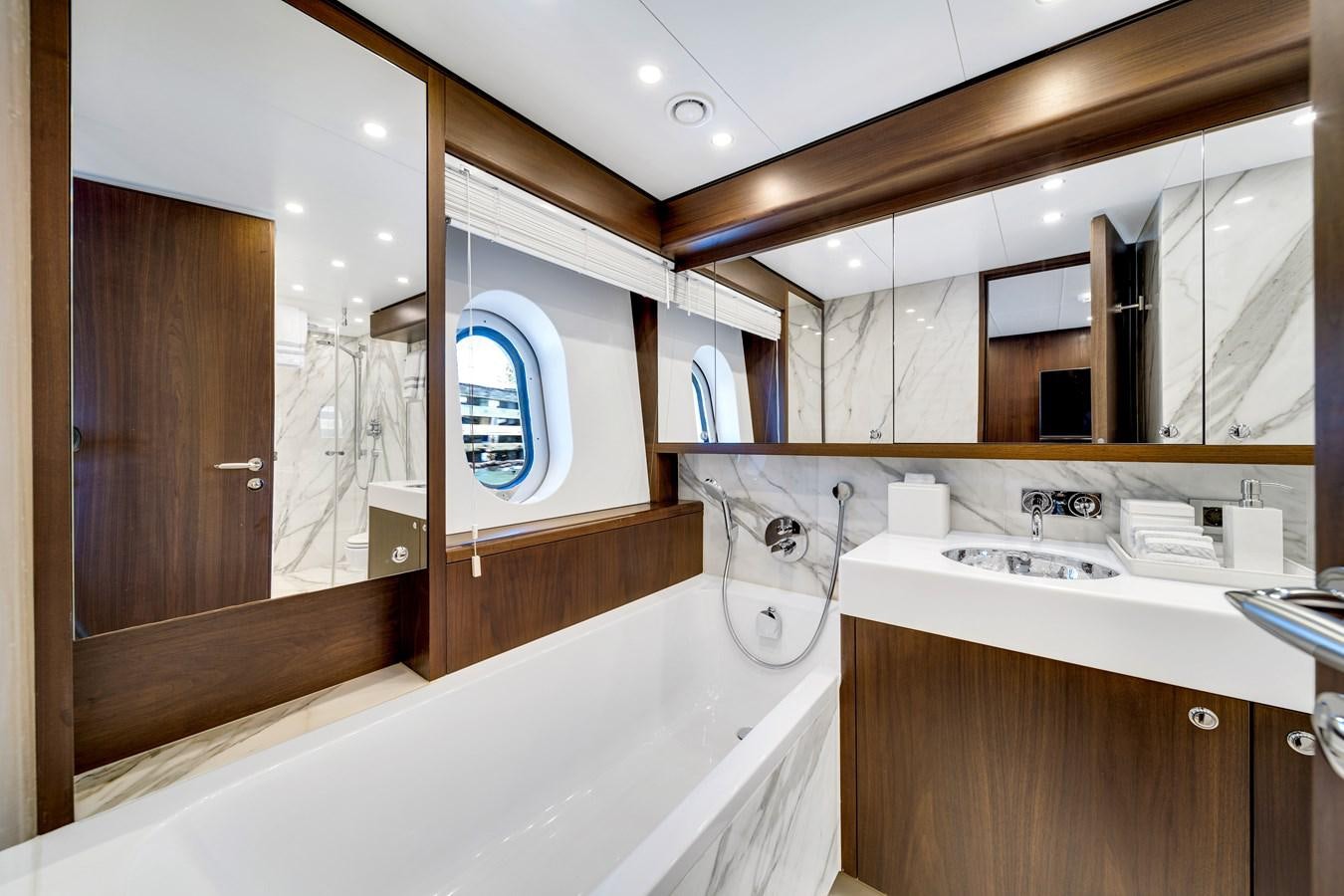 a bathroom with a bathtub and sink aboard MOONEN ROYAL DENSHIP 120 Yacht for Sale