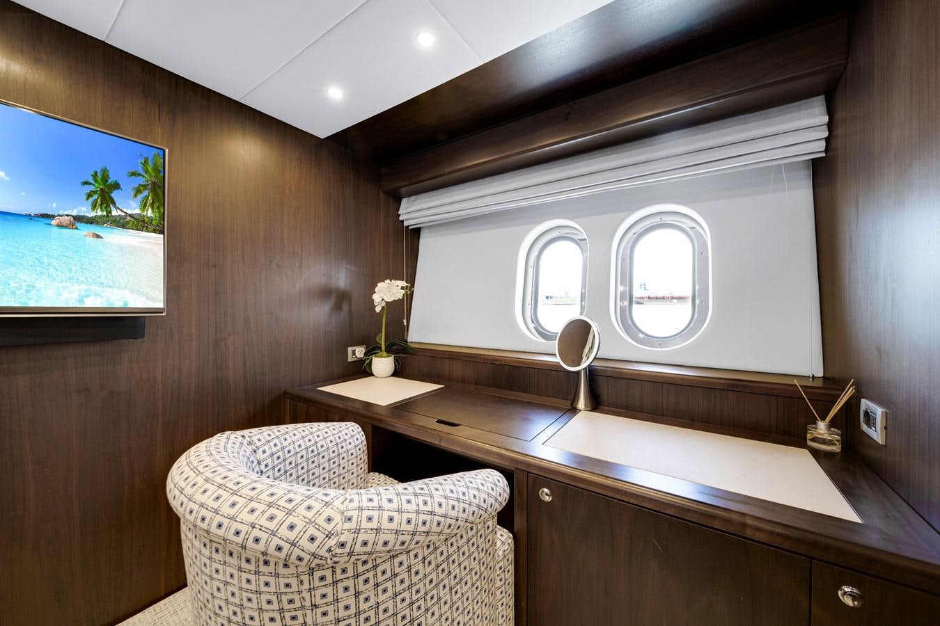 a room with a chair and a tv on the wall aboard MOONEN ROYAL DENSHIP 120 Yacht for Sale