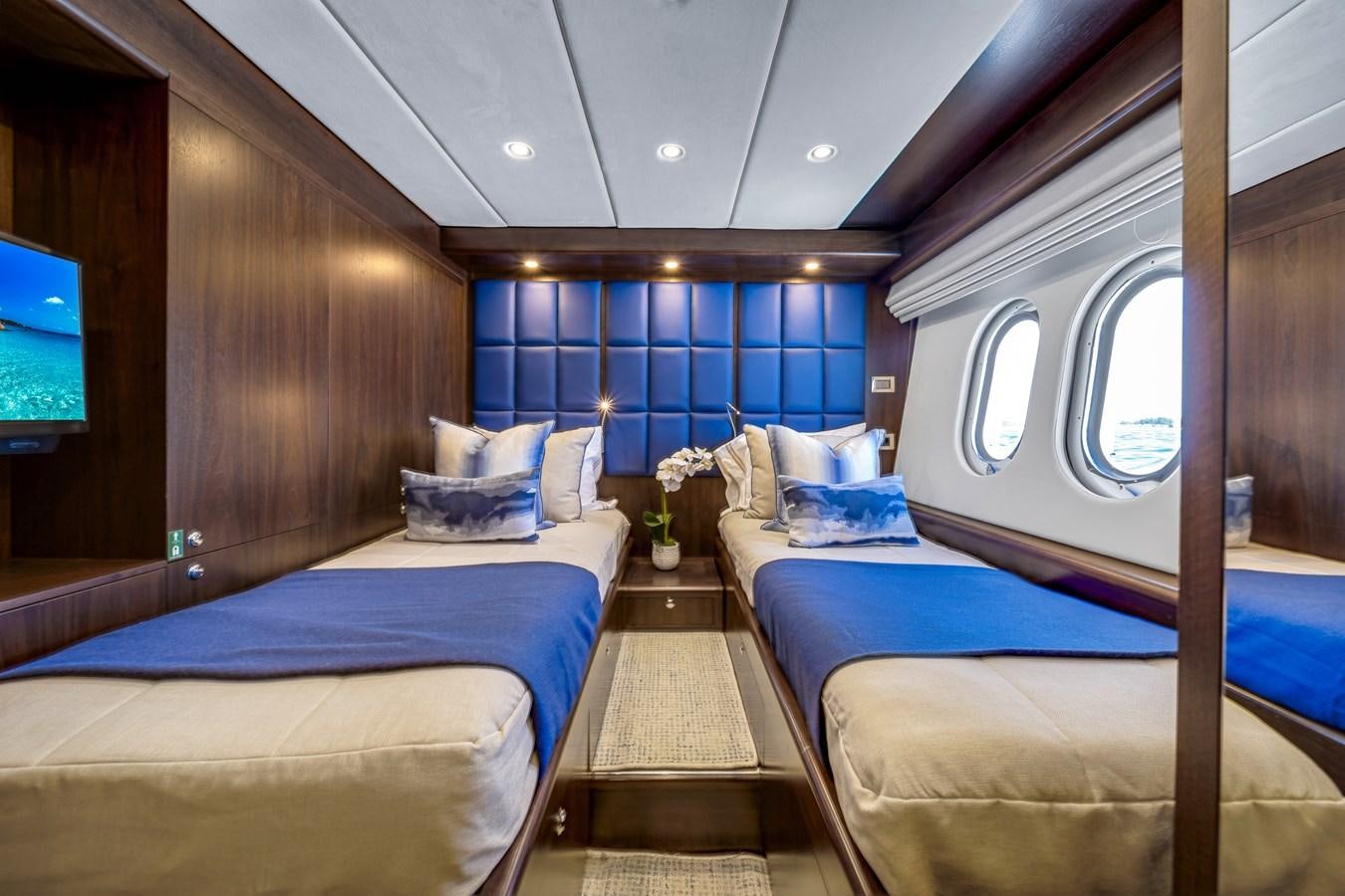 a room with a couple beds aboard MOONEN ROYAL DENSHIP 120 Yacht for Sale
