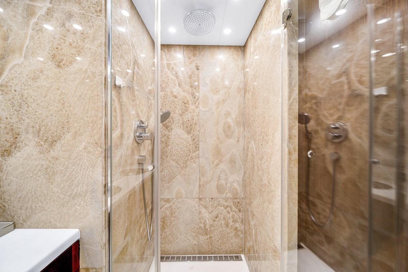 a bathroom with a glass shower aboard MOONEN ROYAL DENSHIP 120 Yacht for Sale