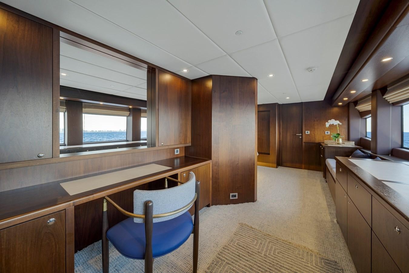 a kitchen with a blue chair aboard MOONEN ROYAL DENSHIP 120 Yacht for Sale