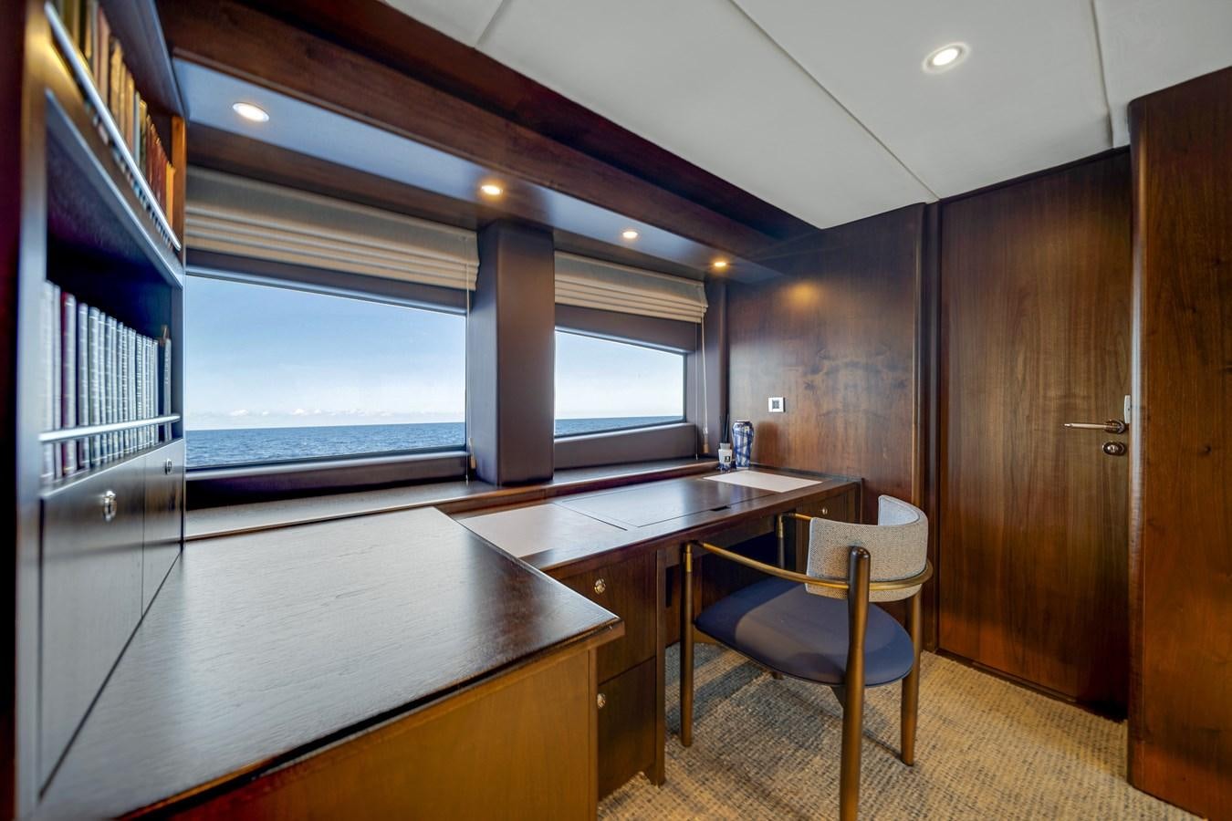 a room with a table and chairs aboard MOONEN ROYAL DENSHIP 120 Yacht for Sale