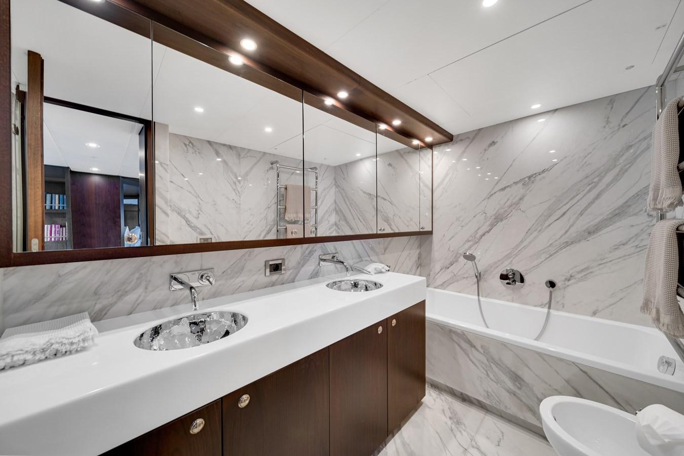 a bathroom with a large mirror aboard MOONEN ROYAL DENSHIP 120 Yacht for Sale