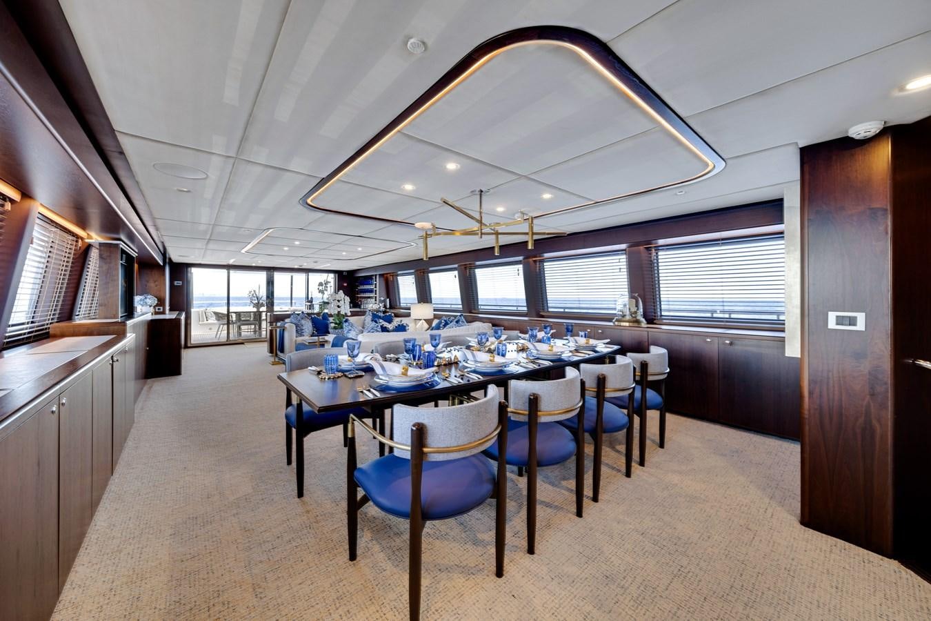 a large kitchen with a table and chairs aboard MOONEN ROYAL DENSHIP 120 Yacht for Sale