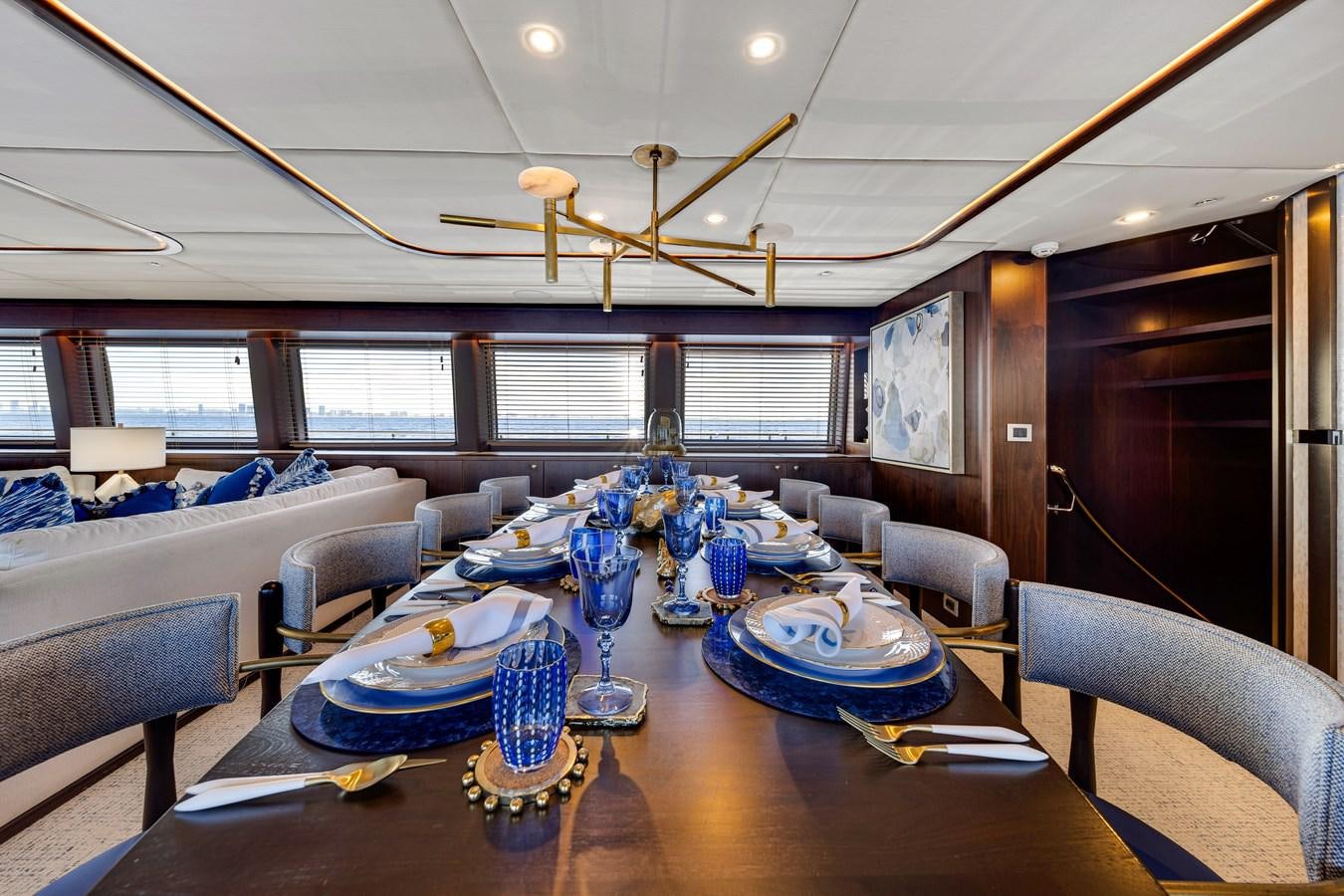 a large living room with a large table and chairs aboard MOONEN ROYAL DENSHIP 120 Yacht for Sale