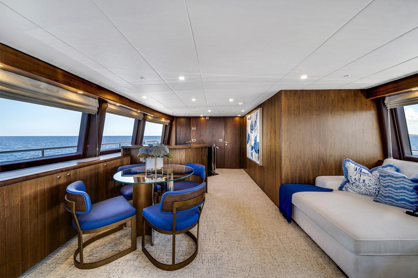 a room with a couch and a table and a window aboard MOONEN ROYAL DENSHIP 120 Yacht for Sale