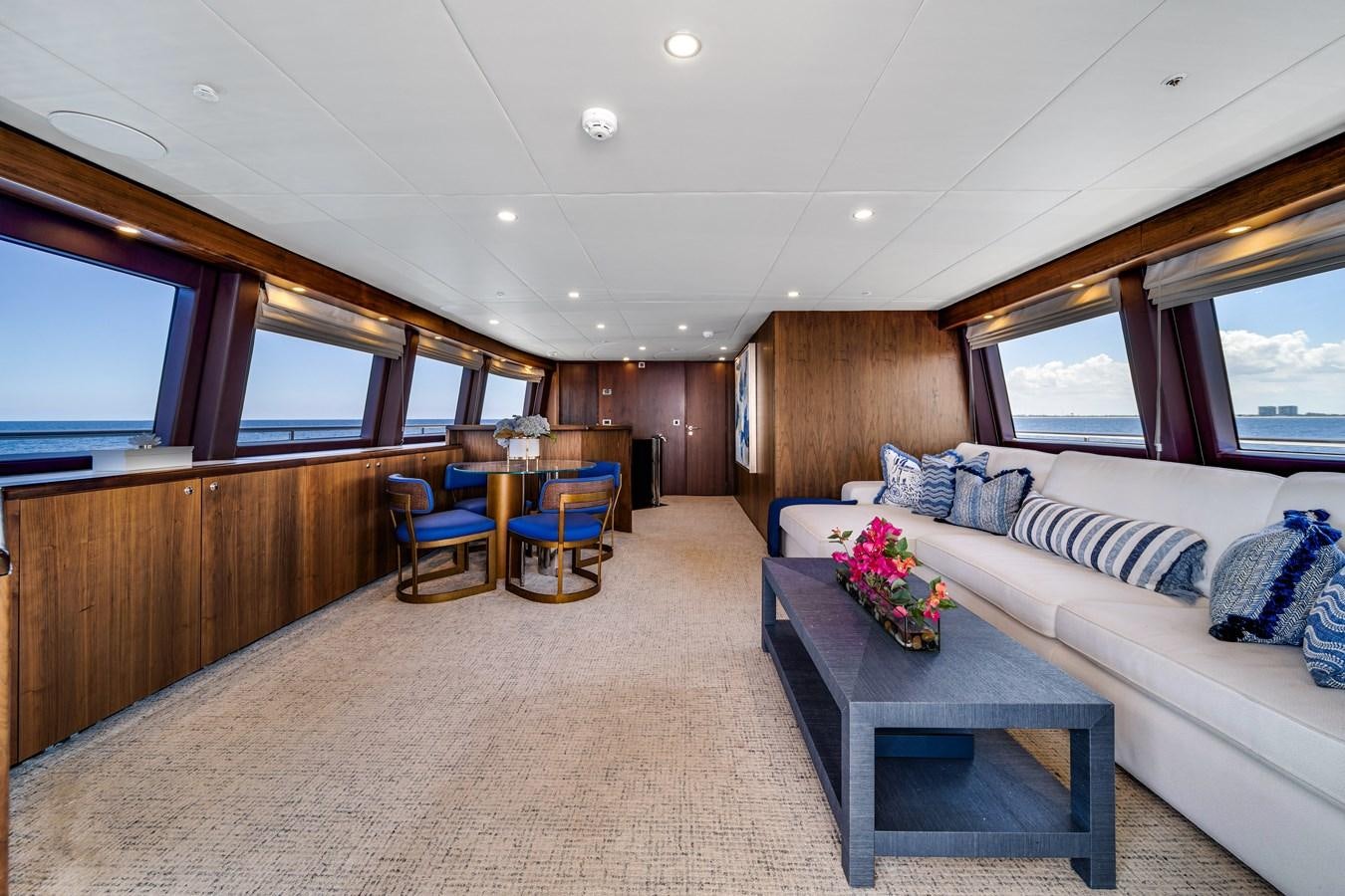 a living room with a couch and a table aboard MOONEN ROYAL DENSHIP 120 Yacht for Sale