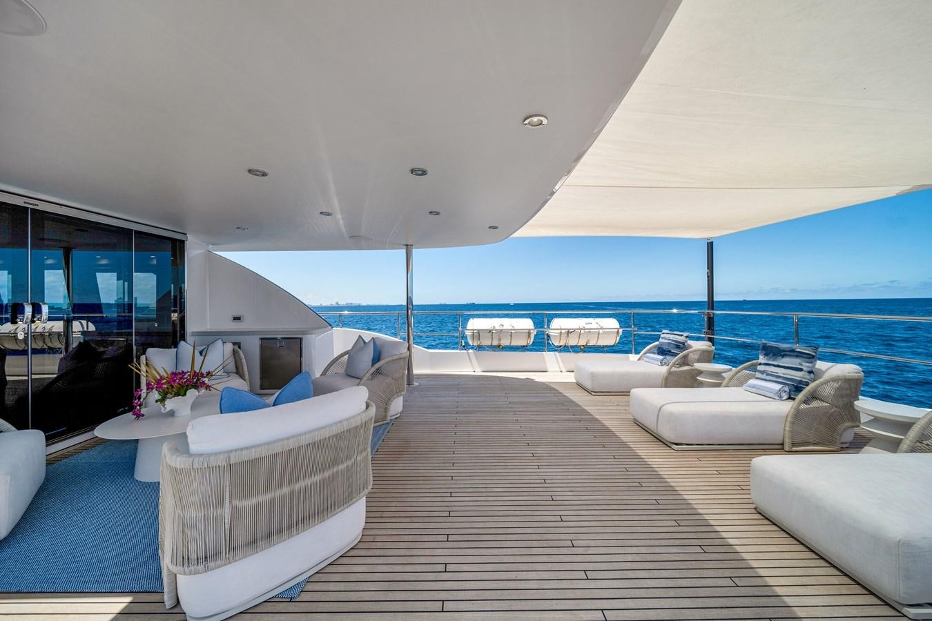 a living room with a large blue ocean aboard MOONEN ROYAL DENSHIP 120 Yacht for Sale