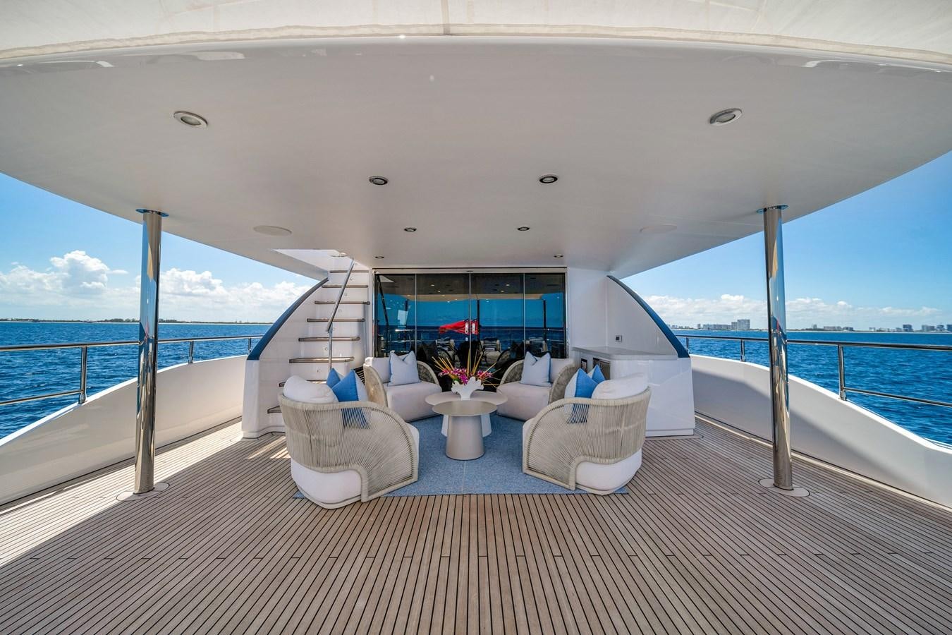 a room with a view of the ocean and a large blue and white boat on the water aboard MOONEN ROYAL DENSHIP 120 Yacht for Sale