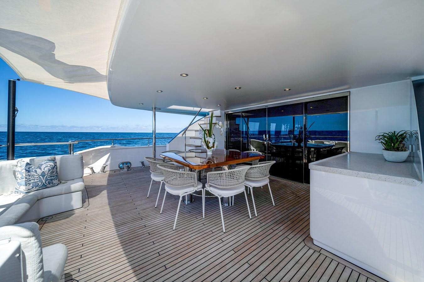 a room with a table and chairs aboard MOONEN ROYAL DENSHIP 120 Yacht for Sale