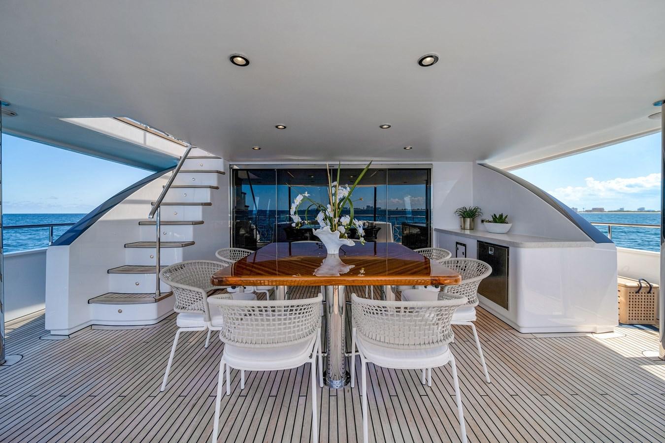 a room with a table and chairs aboard MOONEN ROYAL DENSHIP 120 Yacht for Sale