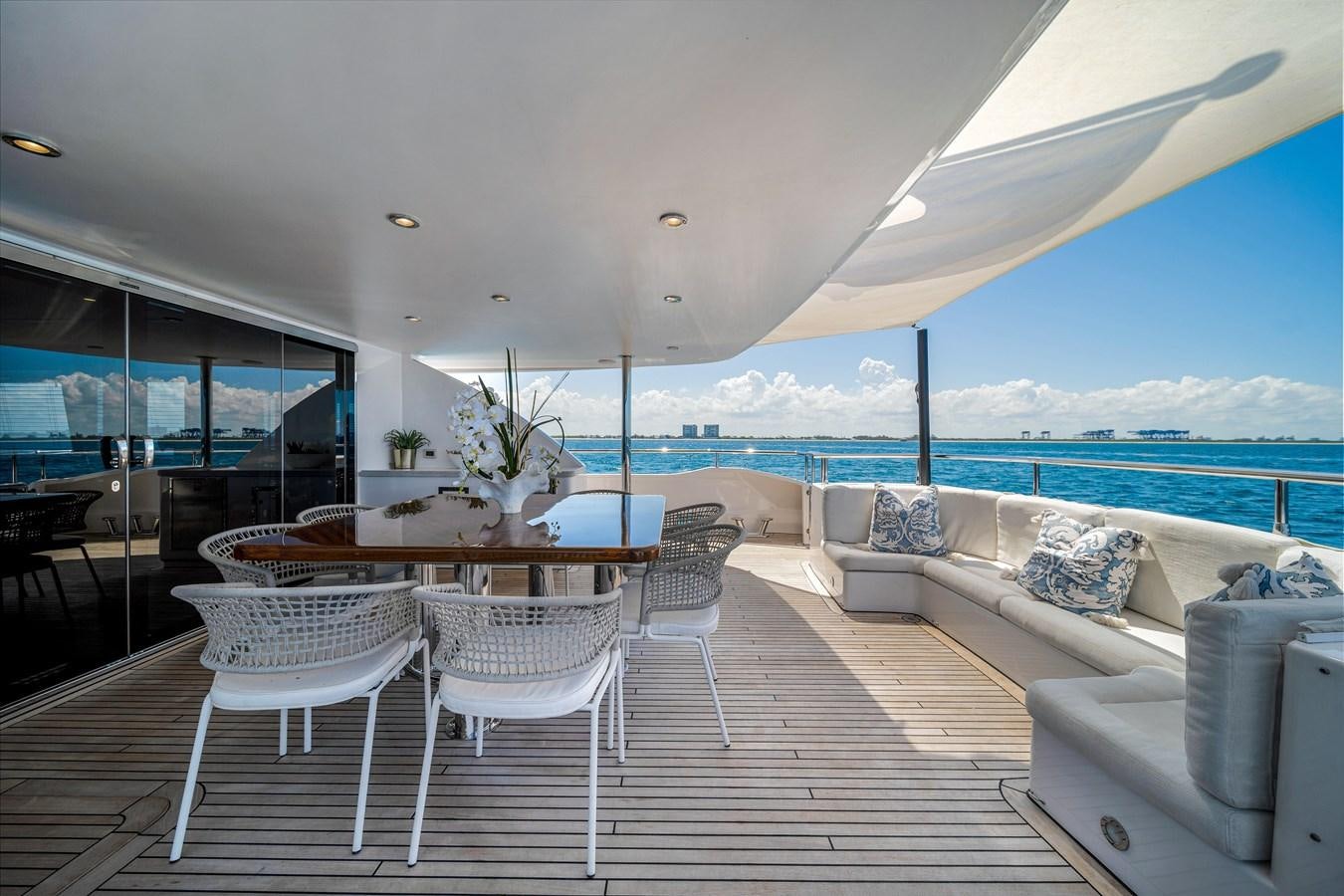 a room with a table chairs and a large window aboard MOONEN ROYAL DENSHIP 120 Yacht for Sale