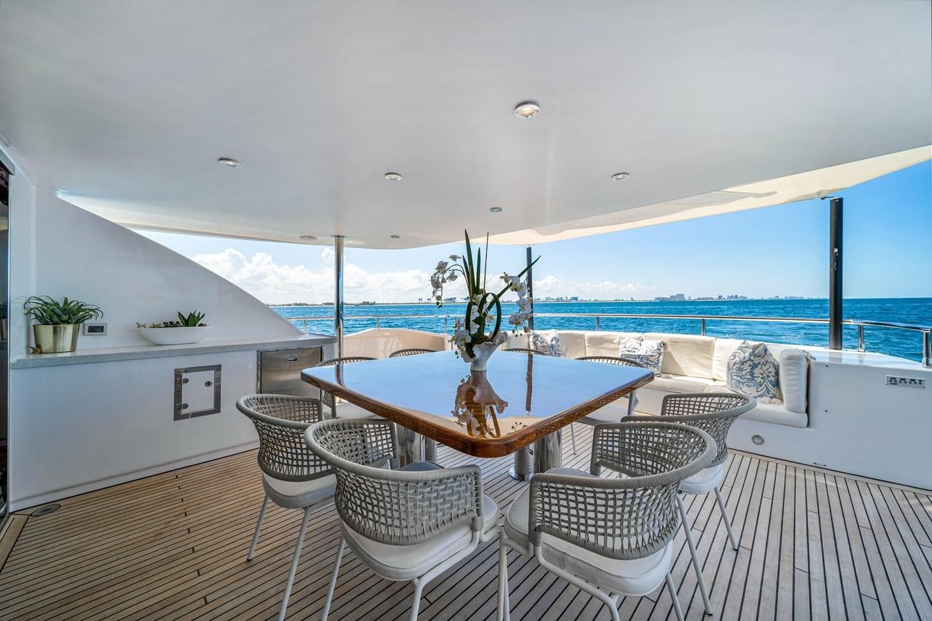 a large white room with a table and chairs and a large body of water aboard MOONEN ROYAL DENSHIP 120 Yacht for Sale