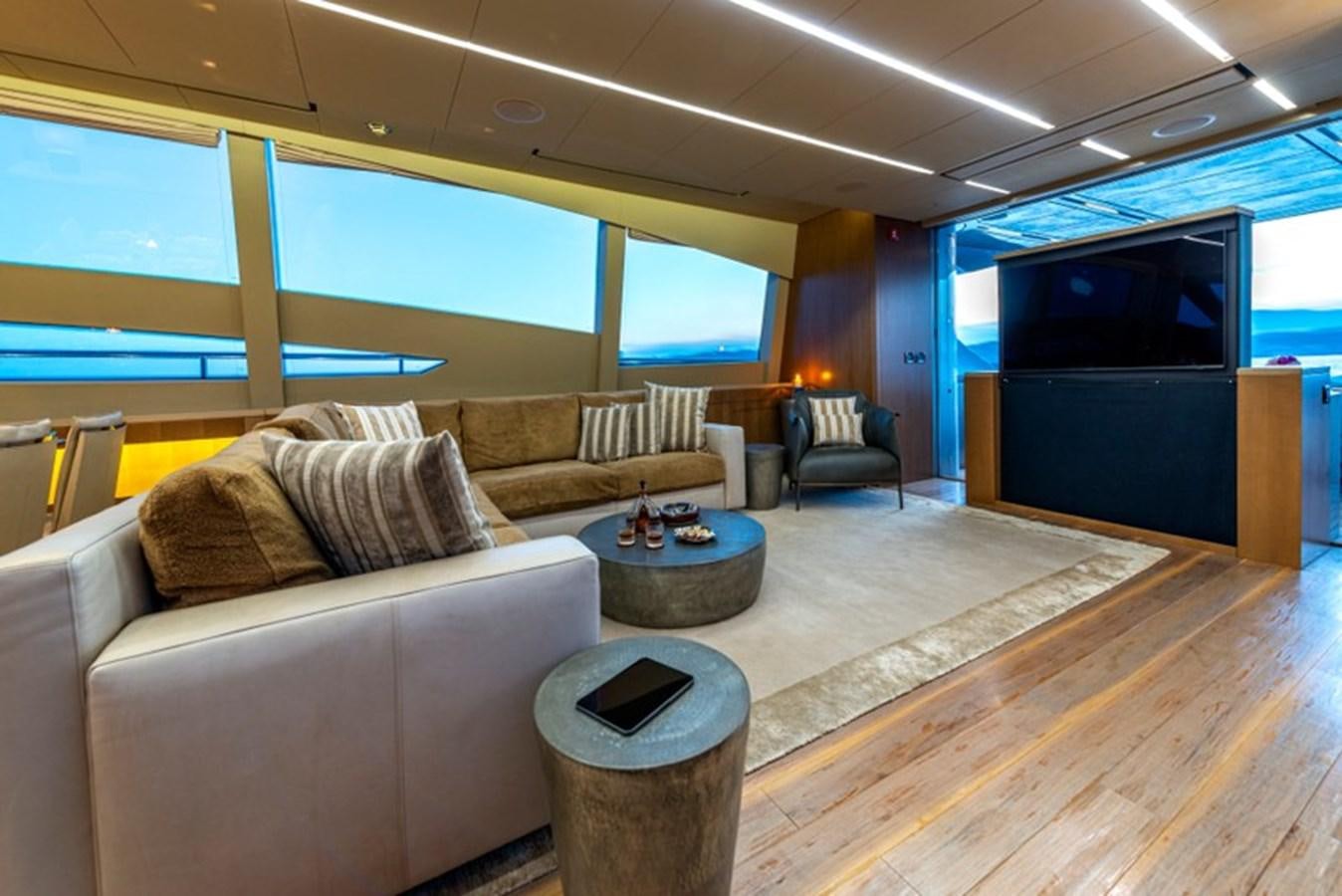 a living room with a couch and a television aboard LEVANTINE II Yacht for Sale