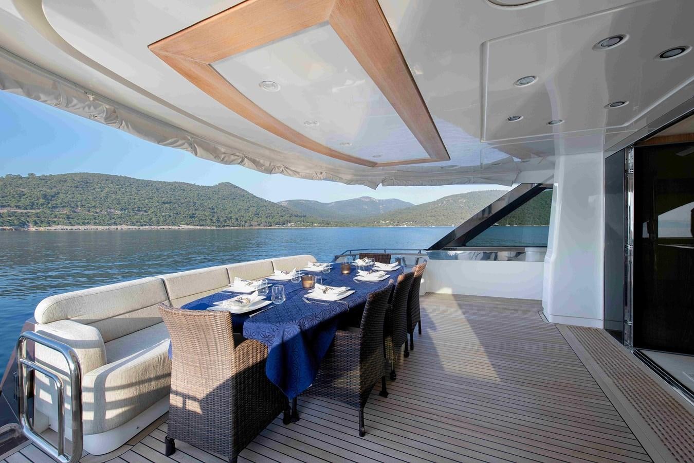 a table and chairs on a deck aboard ANDIAMO Yacht for Sale