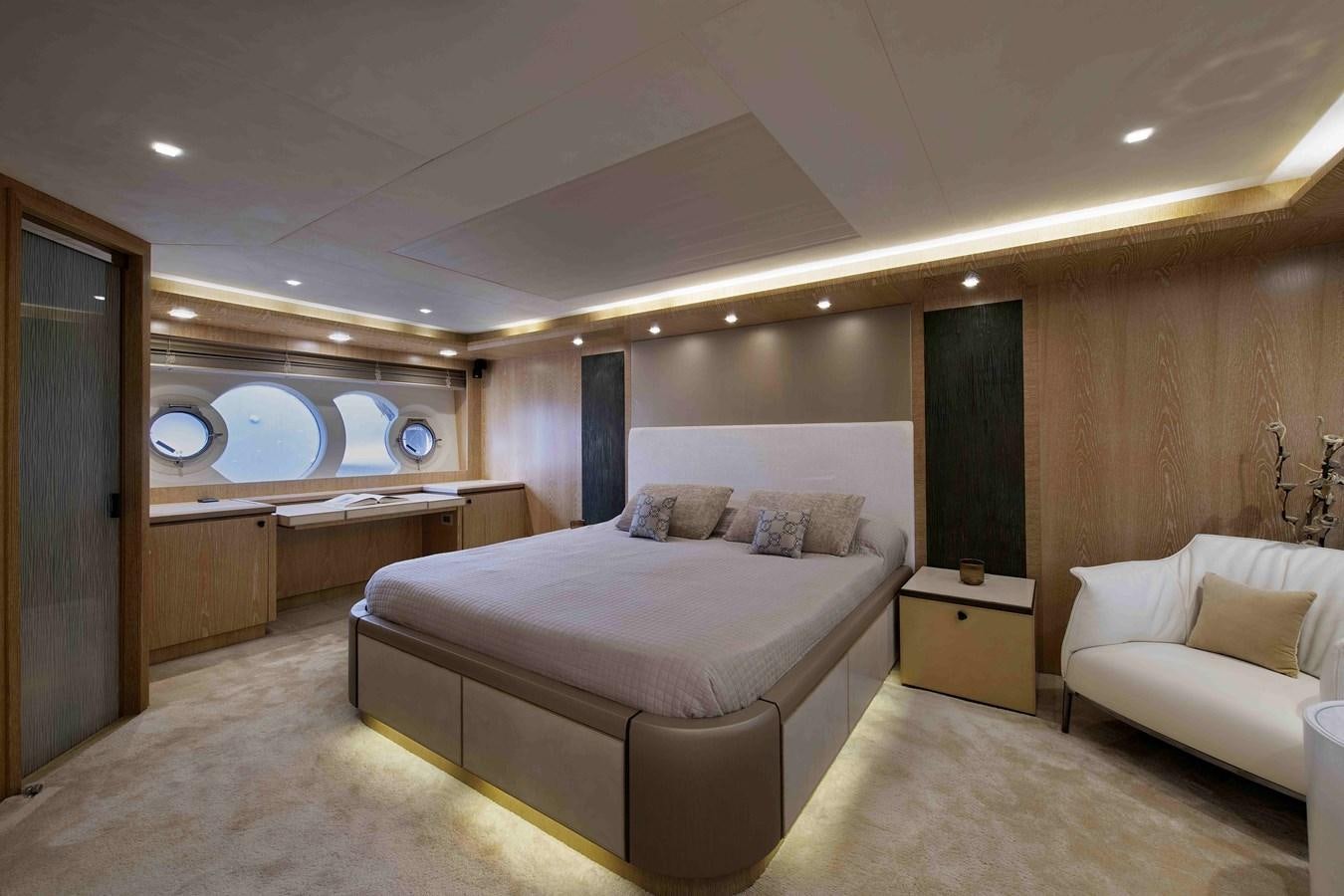 a room with a bed and a chair aboard ANDIAMO Yacht for Sale
