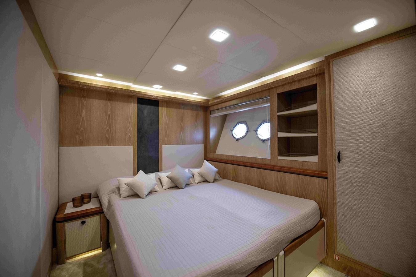 a bedroom with a bed and a mirror aboard ANDIAMO Yacht for Sale