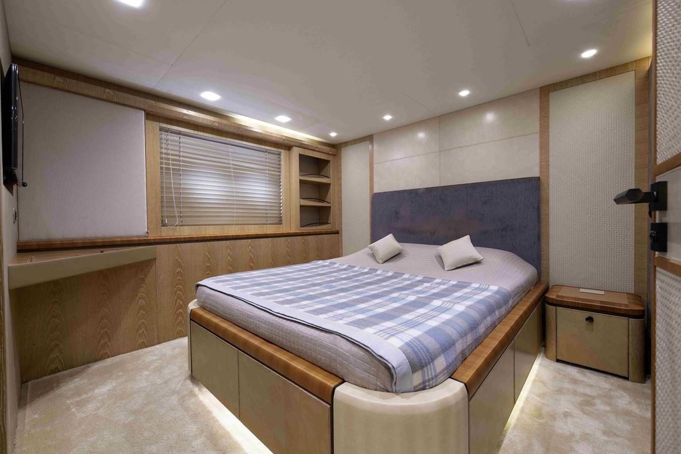 a bedroom with a bed and a window aboard ANDIAMO Yacht for Sale