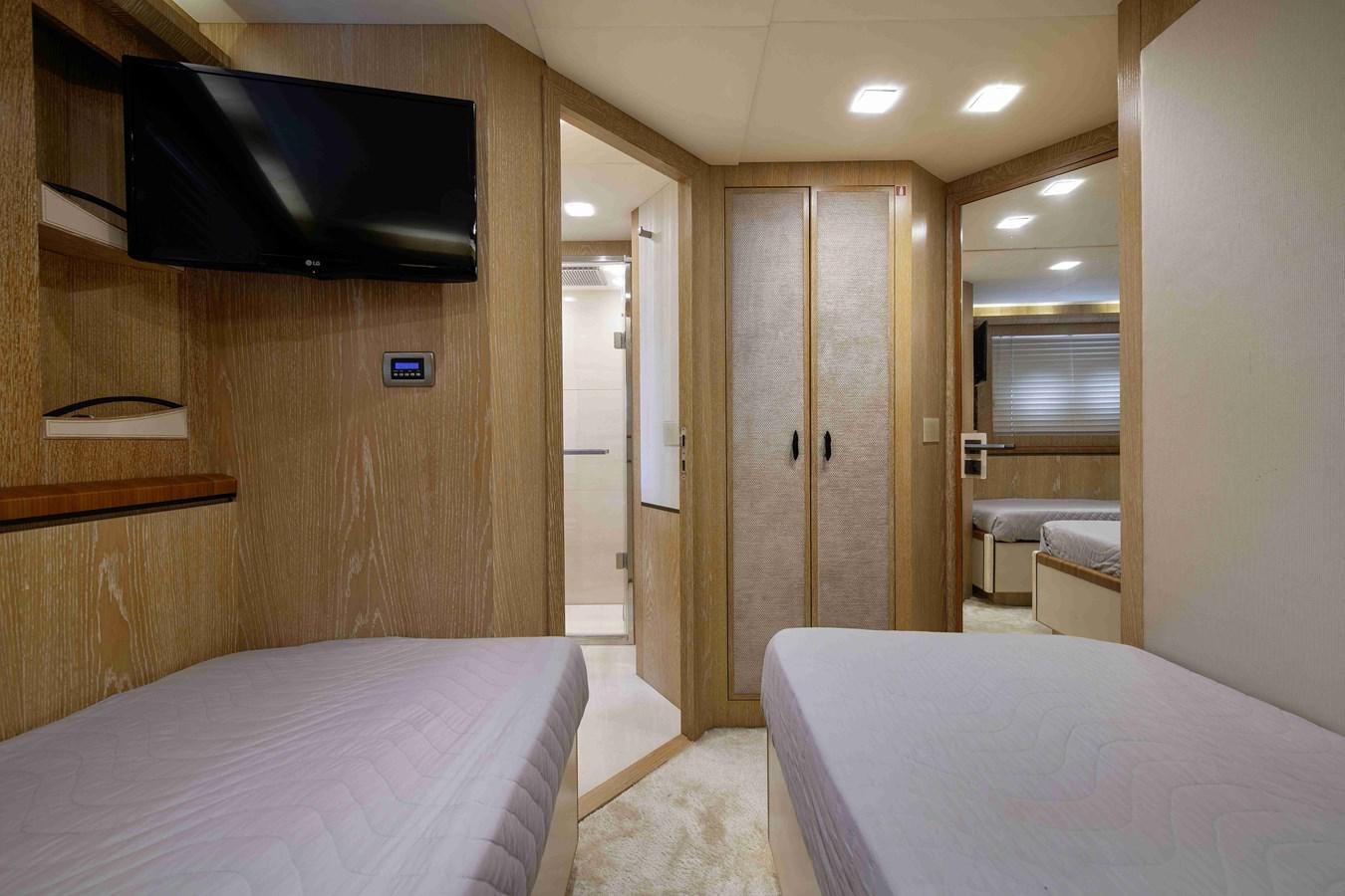 a hotel room with a bed and tv aboard ANDIAMO Yacht for Sale