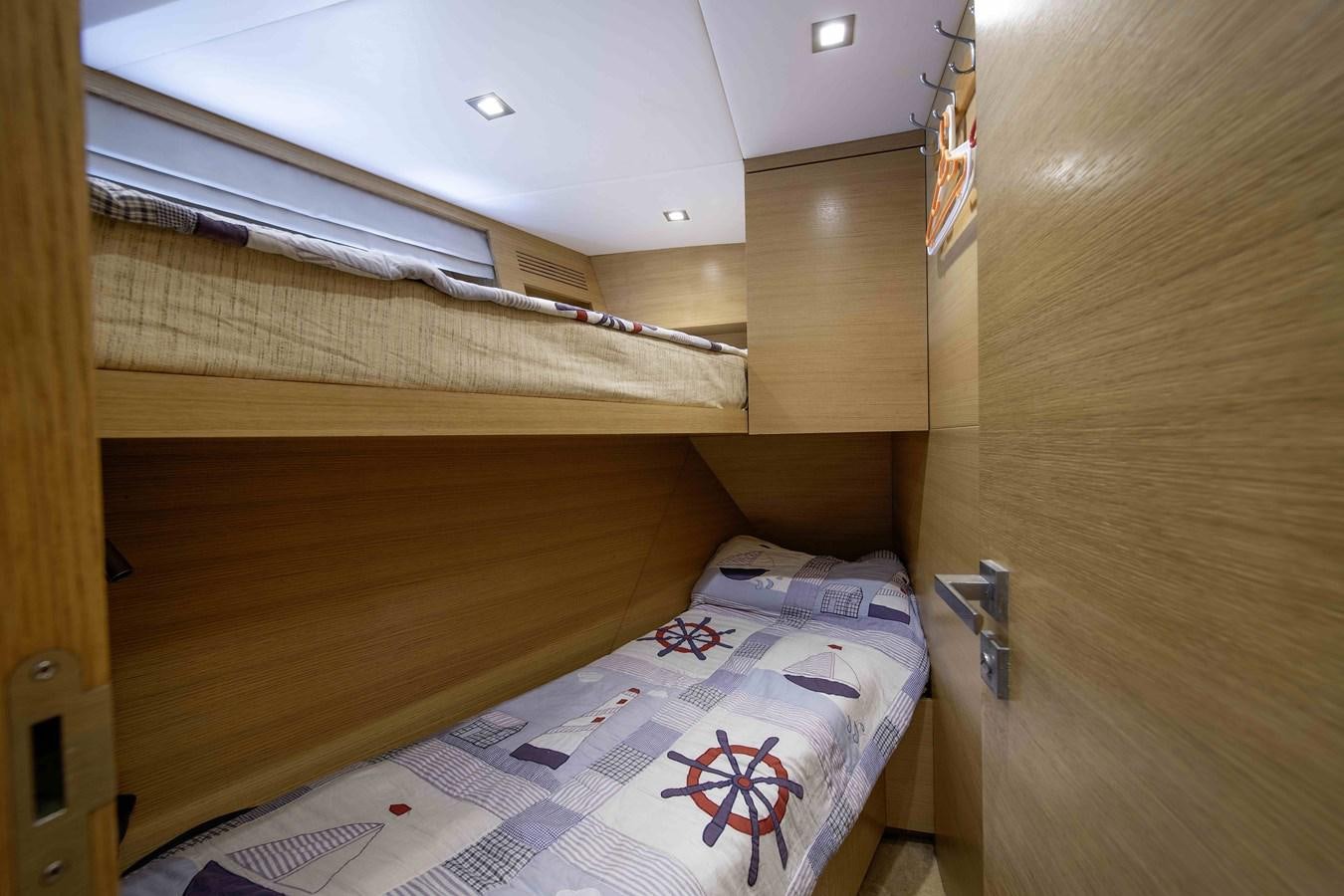 a bunk bed with a wooden frame aboard ANDIAMO Yacht for Sale