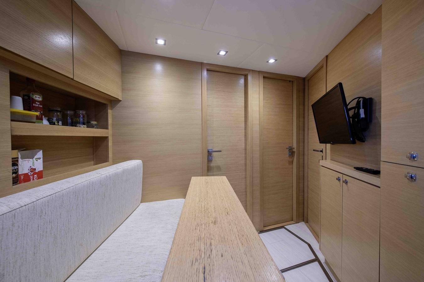 a room with a bed and a television aboard ANDIAMO Yacht for Sale
