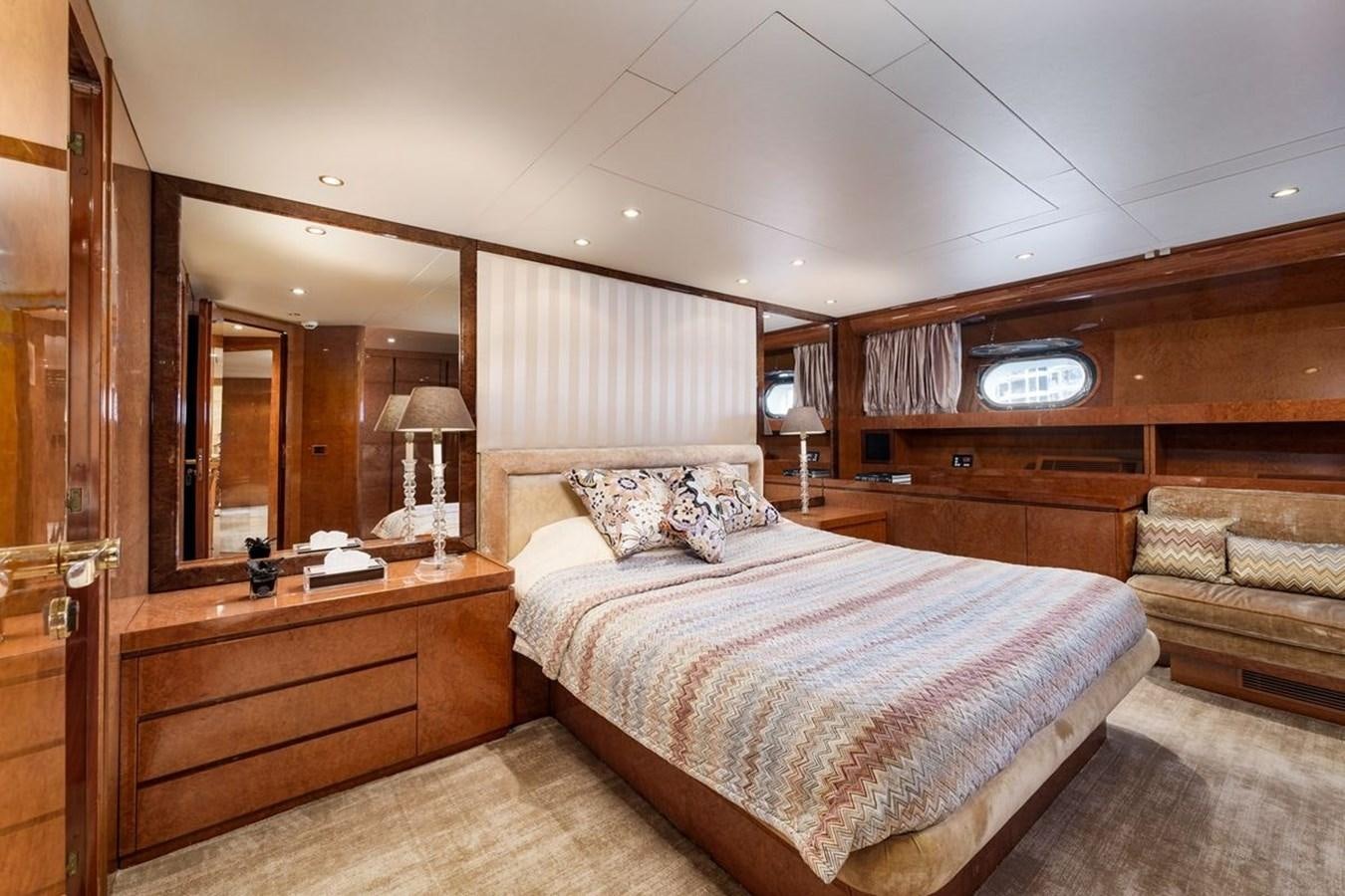 a bedroom with a bed and a mirror aboard ALIA 7 Yacht for Sale
