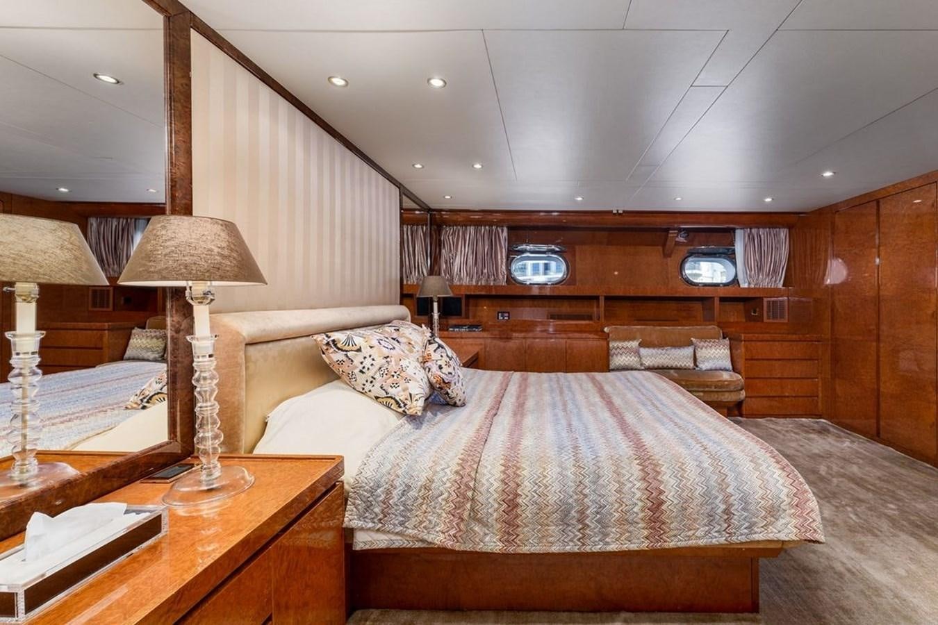a bedroom with a bed and a lamp aboard ALIA 7 Yacht for Sale