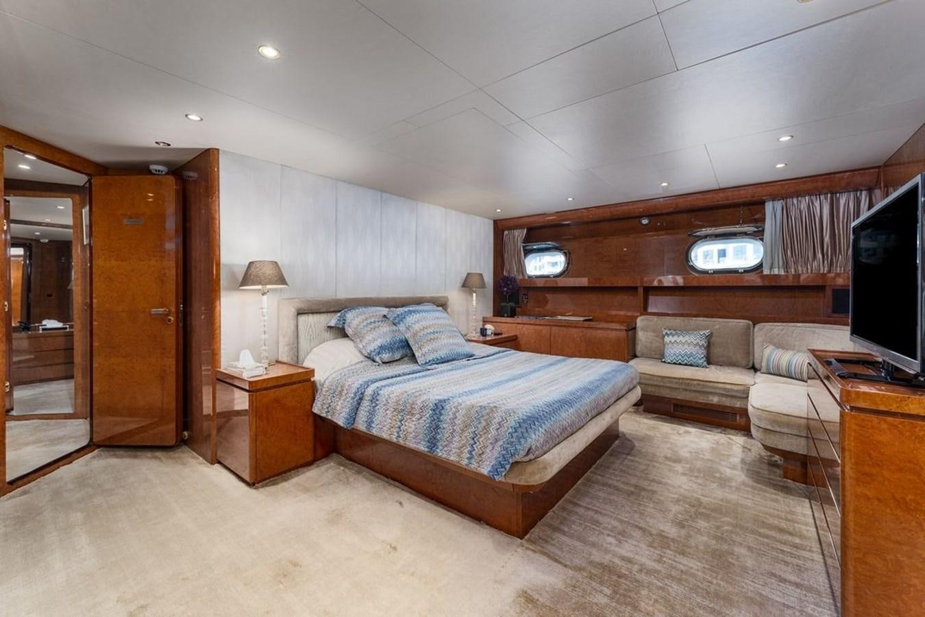 a bedroom with a bed and a couch aboard ALIA 7 Yacht for Sale