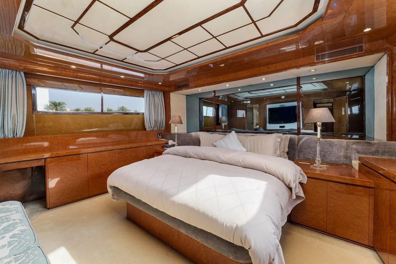 a room with a bed and a wood cabinet aboard ALIA 7 Yacht for Sale