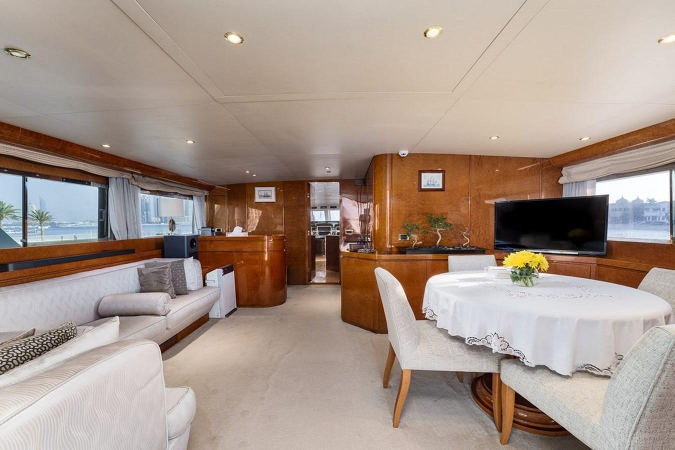 a large living room with a dining table and chairs aboard ALIA 7 Yacht for Sale