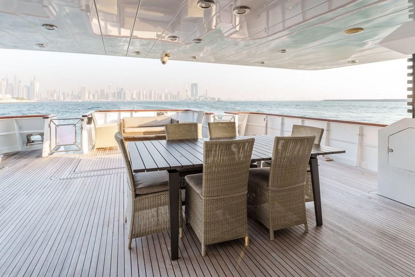 a table and chairs on a deck aboard ALIA 7 Yacht for Sale