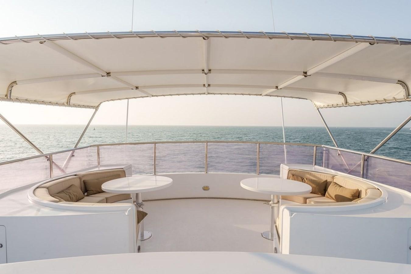 a room with a view of the ocean and a beach aboard ALIA 7 Yacht for Sale