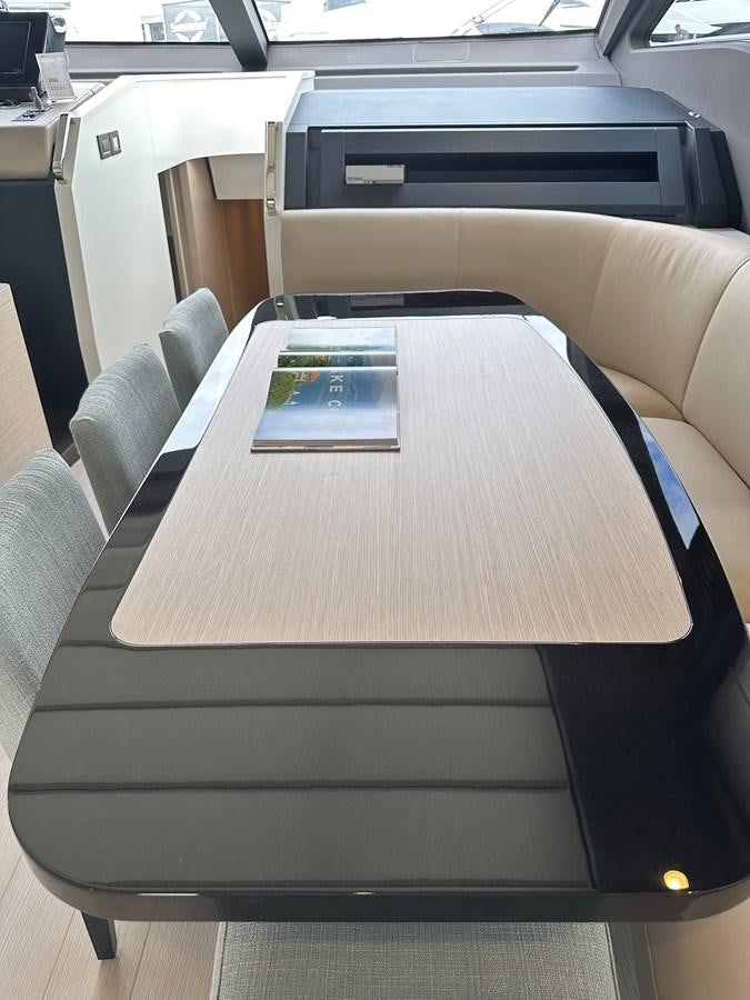 a table with a book on it aboard SUNSET 8 Yacht for Sale