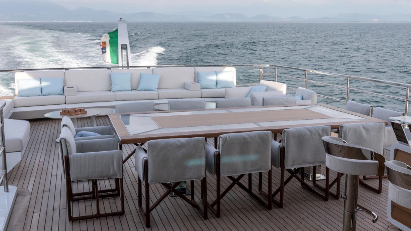 a table with chairs on it aboard GOLDENEYE Yacht for Sale