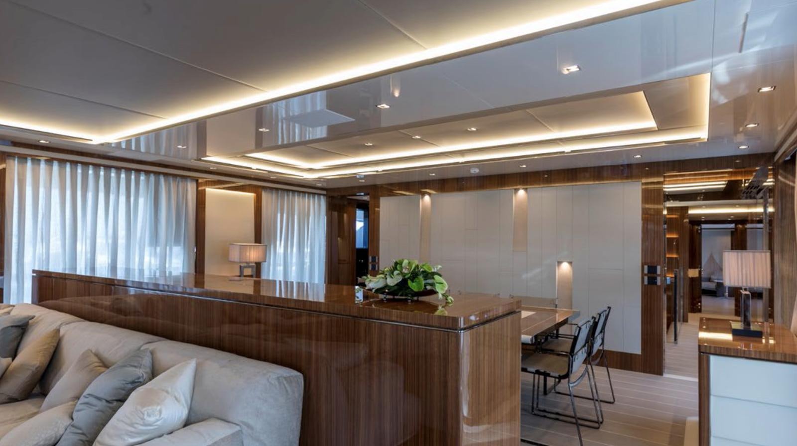 a living room with a couch and a table aboard GOLDENEYE Yacht for Sale