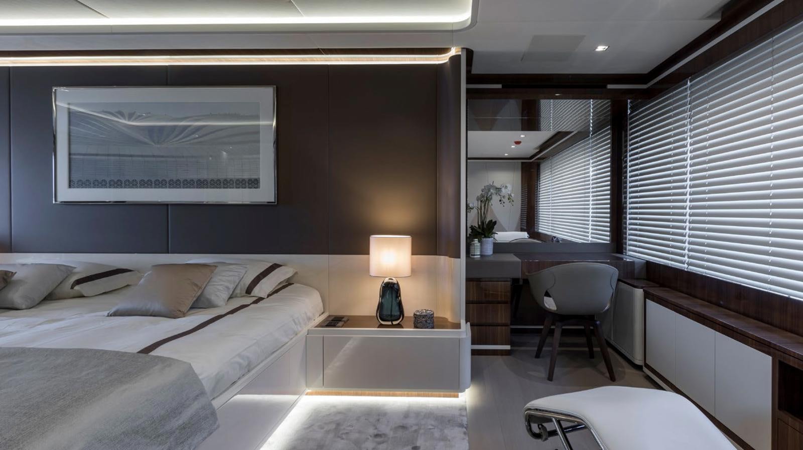 a room with a bed and a desk aboard GOLDENEYE Yacht for Sale