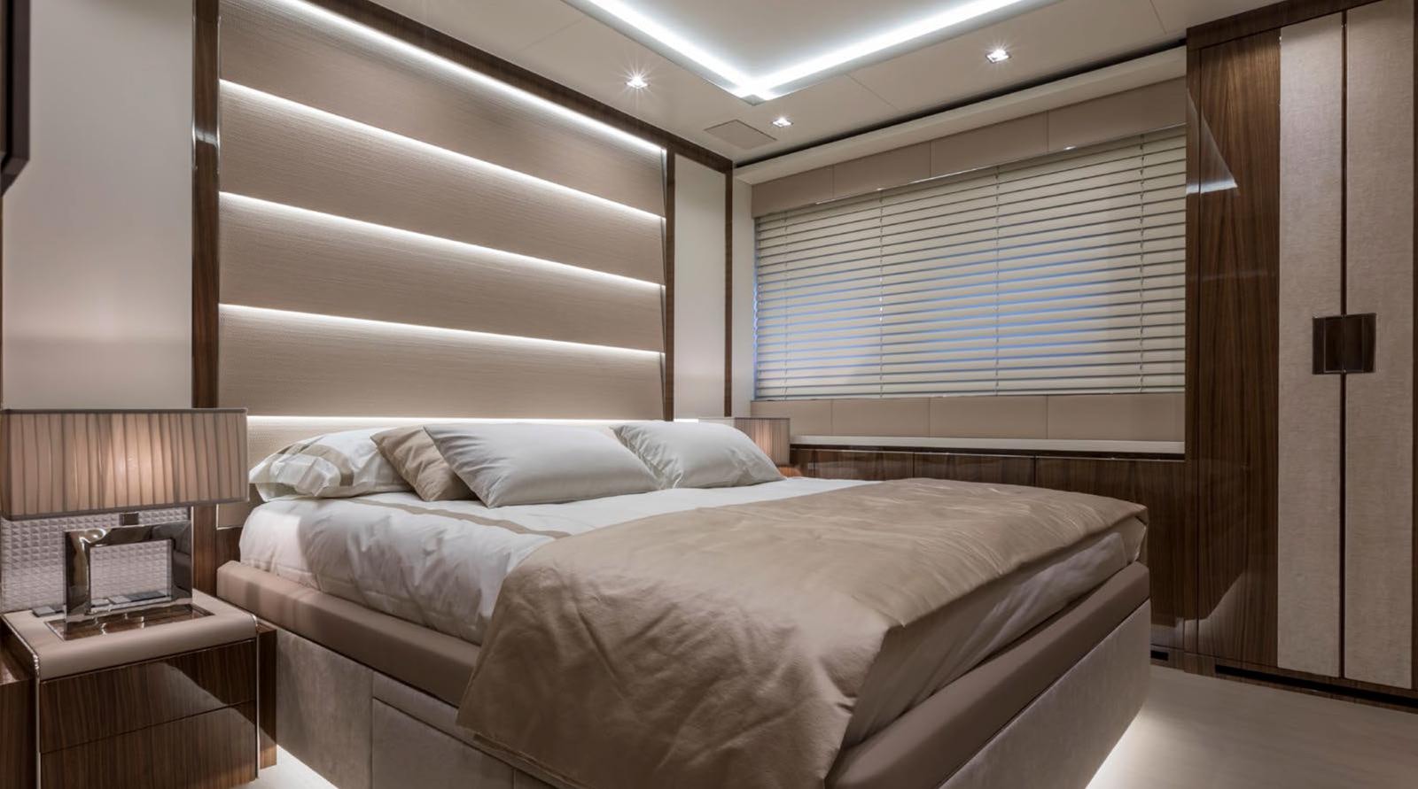 a room with a bed and a window aboard GOLDENEYE Yacht for Sale
